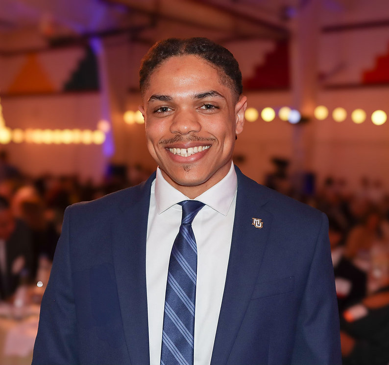 Jaren Wilson in a blue suit with MU pin